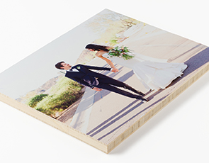 Newlywed couple holding hands by the beach on a Custom Photo Mounting Board
